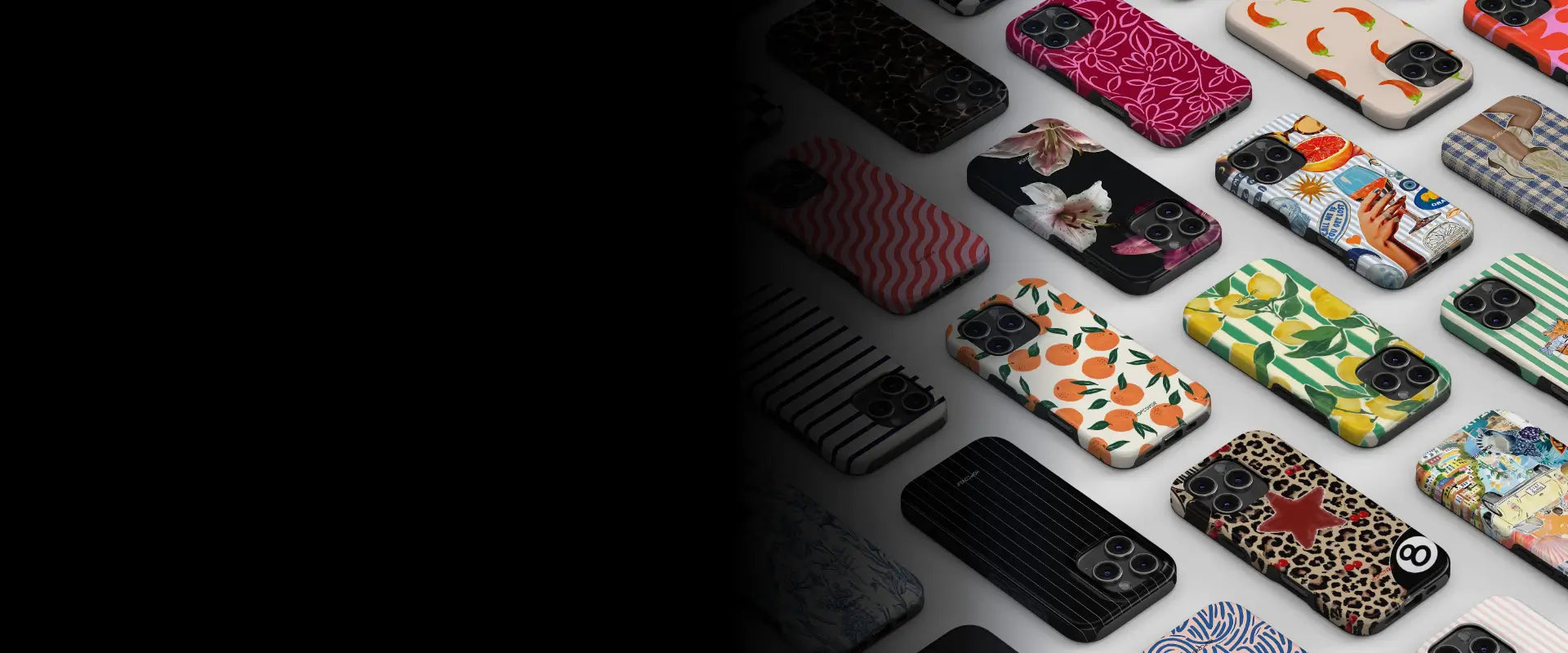 A collection of colorful patterned phone cases arranged on a light surface, with a large black area on the left side of the frame.